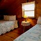 Upstairs are two queen beds in the Mountain Magic Cabin