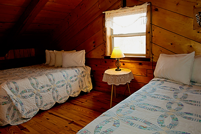 Upstairs are two queen beds in the Mountain Magic Cabin