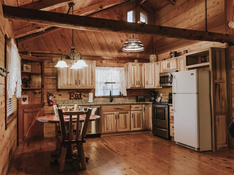 The cabin's kitchen is fully furnished, including dishes, pots/pans, utensils, silverware and more.