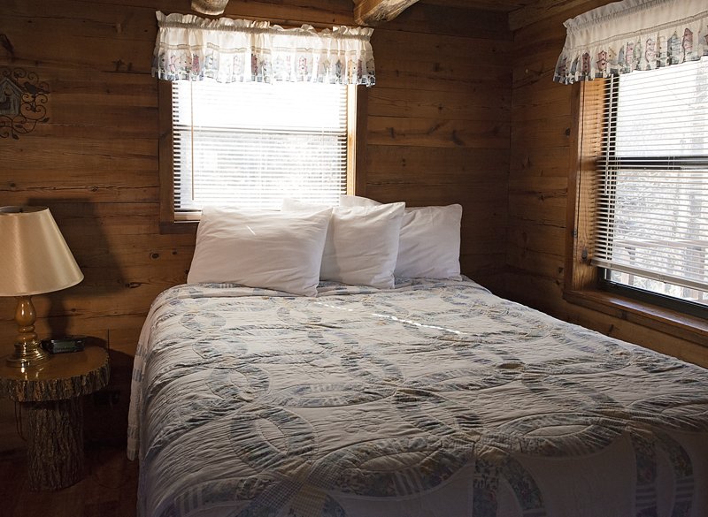 The queen bed located on the main floor (adjacent to the living area).