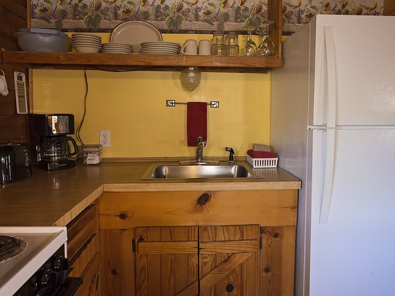 The cabin's kitchen is fully furnished, including coffeemaker and full-size fridge.