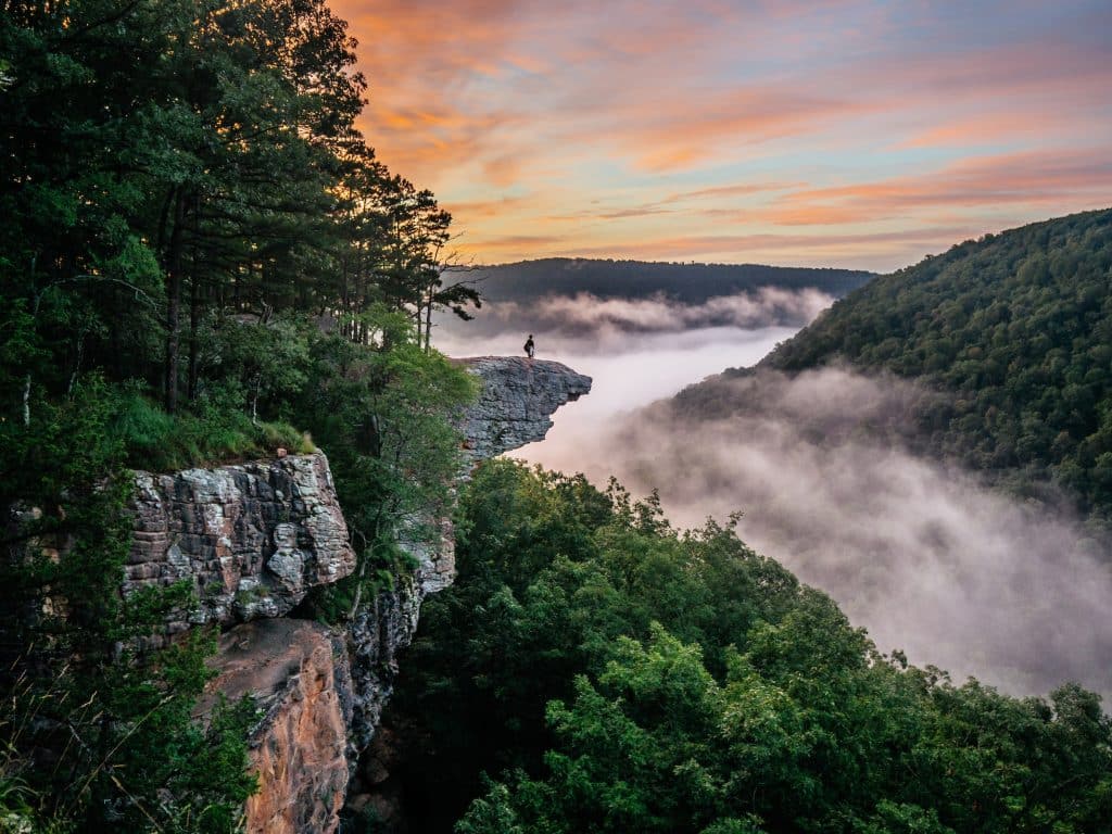 Hiker on Whitaker Point / Hawksbill Crag, one of the most popular and visually stunning trails in upper Buffalo River country.