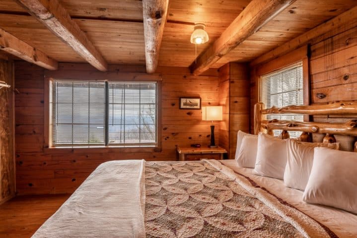The master bedroom with adjacent private showerbath in the Arkansas Cabin.