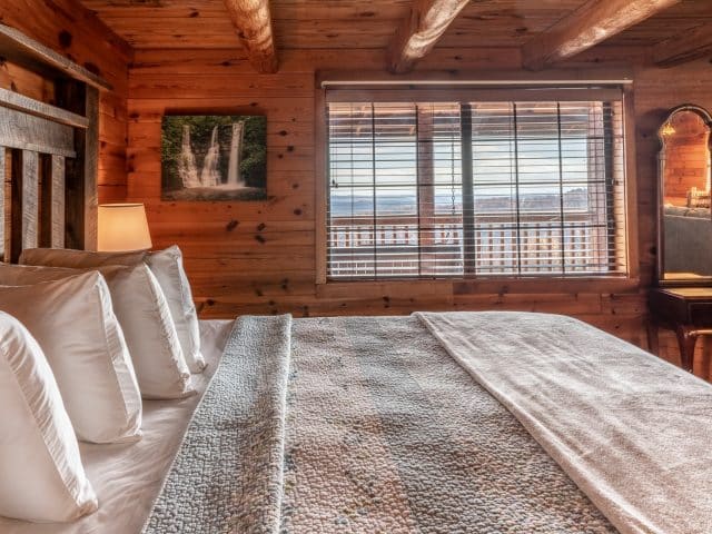 Another view of the king bed in the Buffalo River Cabin