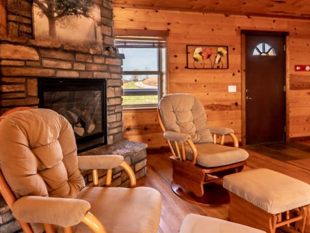 Relax in spacious comfort in the living and dining area of the Mountain Sunset Cabin, complete with romantic gas fireplace.
