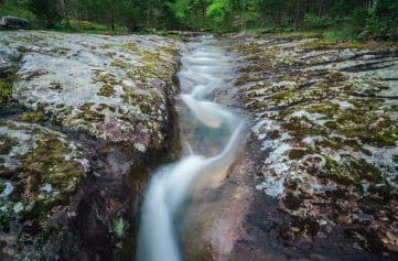 Water flowing through a channel eroded by Sweden Creek.