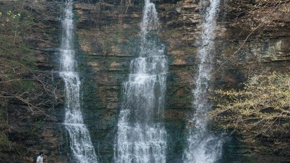 A hiker takes in the view of Triple Falls.