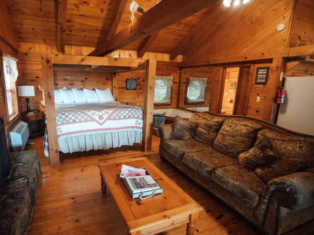 The Mountain Sunrise Cabin features an open floor plan with king-size bed, jacuzzi tub for two and romantic woodburning fireplace.