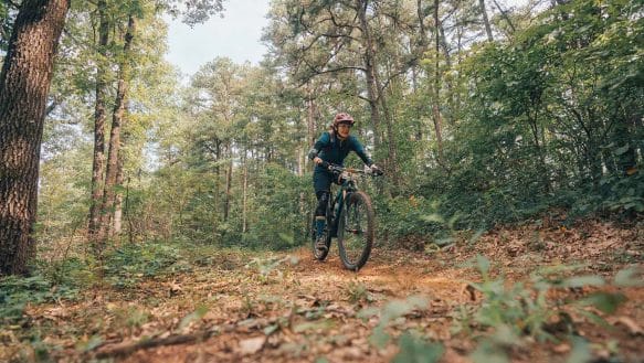 Mountain Biker riding through forest on Upper Buffalo Bike Trails