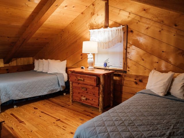 The Mountain Magic Cabin's upstairs sleeping loft is a great place to tuck the kids on a family vacation.