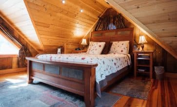 The cabin's loft is furnished with a comfortable queen-size bed.