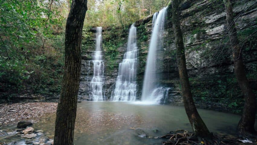 A view through tree of Triple Falls.