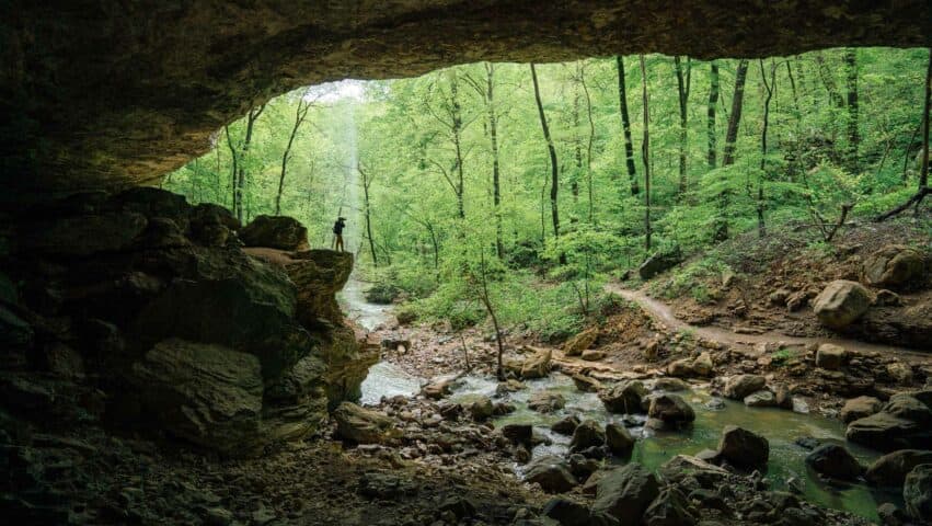 A hiker in Cobb Cave along the Lost Valley Trail