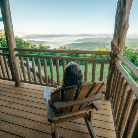 A woman takes in the view from one of the Riverwind Lodge balcony's.
