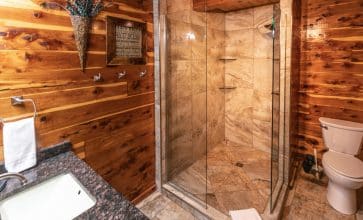 The Waterfall Cabin features a beautifully rustic showerbath.
