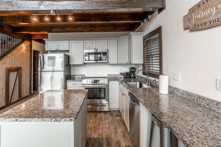 Enjoy a spacious kitchen with full-size appliances in the Foxfire Cabin.