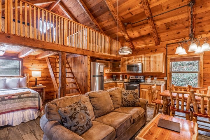 Cabin 2 features a comfy living and dining area, sleeping loft and woodburning fireplace.