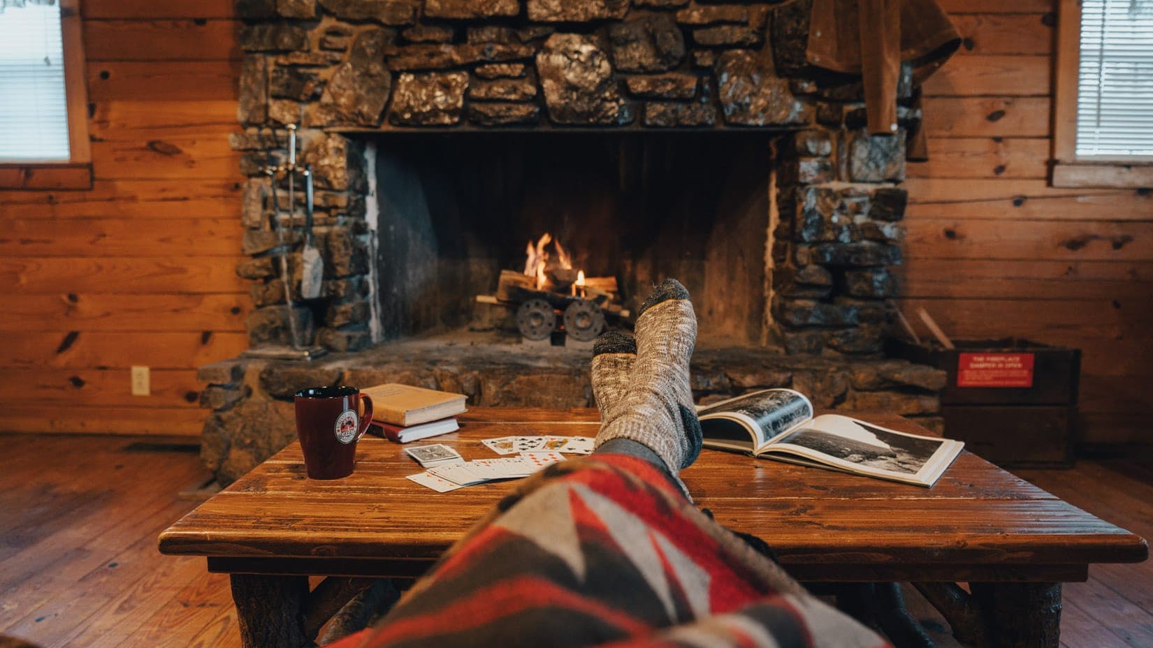 reading by a fireplace