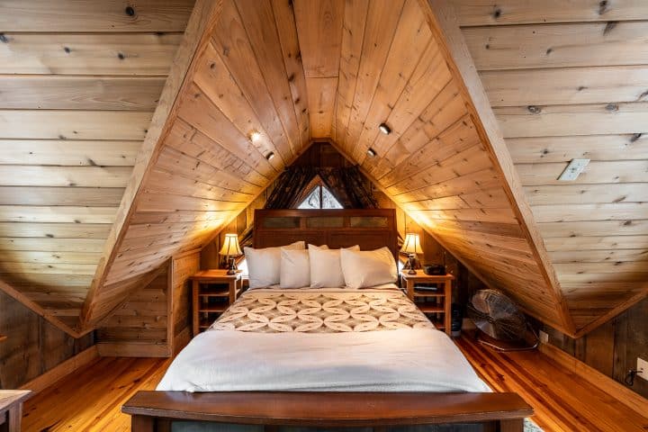 The cabin's loft is furnished with a comfortable queen-size bed.