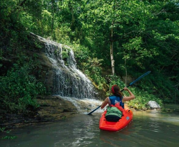 kayaking by a waterfall