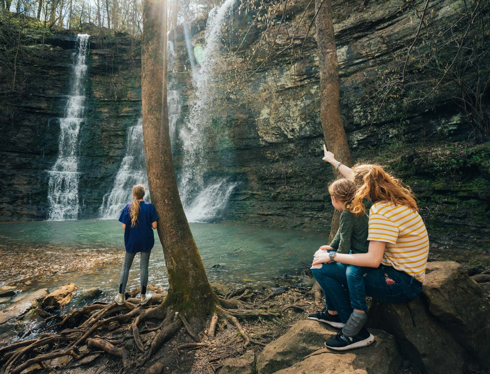 A mom and her children admiring a Buffalo River country waterfall.