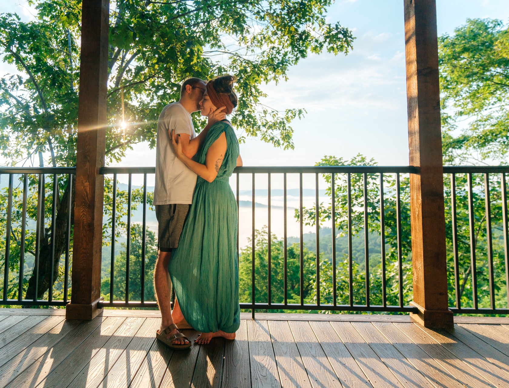 Couple on the deck of a romantic Buffalo Outdoor Center cabin.