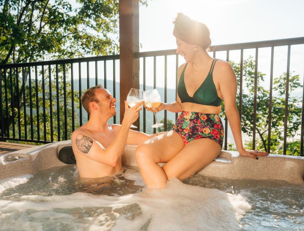 Couple in hot tub at BOC Cabin