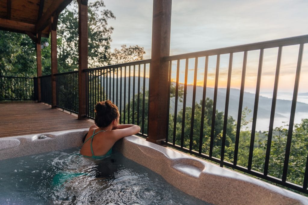 Enjoying the sunrise view from the hot tub at the Wanderlust Cabin.