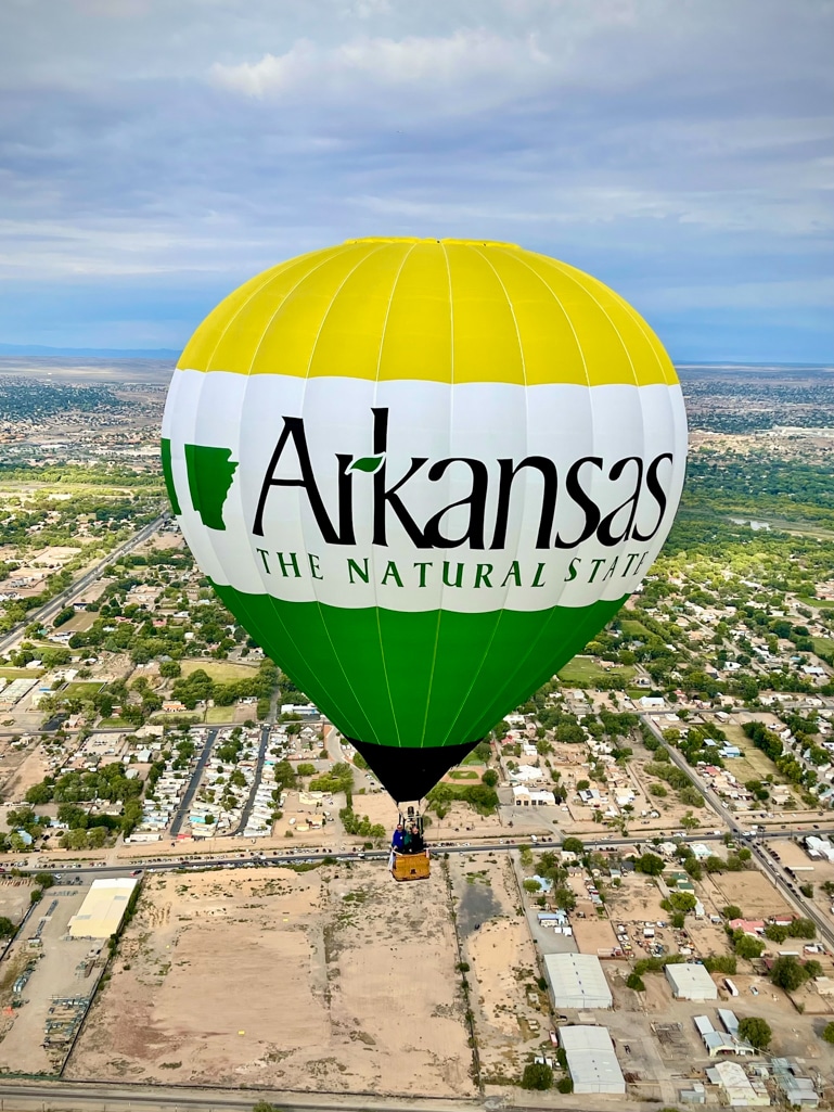 The Miss Arkansas hot air balloon flying over Albuquerque at the 2022 Balloon Fiesta. (Image courtesy John Petrehn)