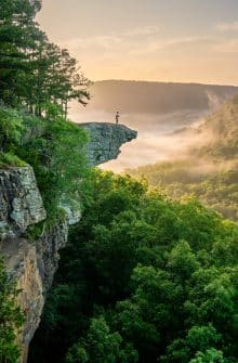 A Hiker on Whitaker Point (Hawksbill Crag) at sunrise
